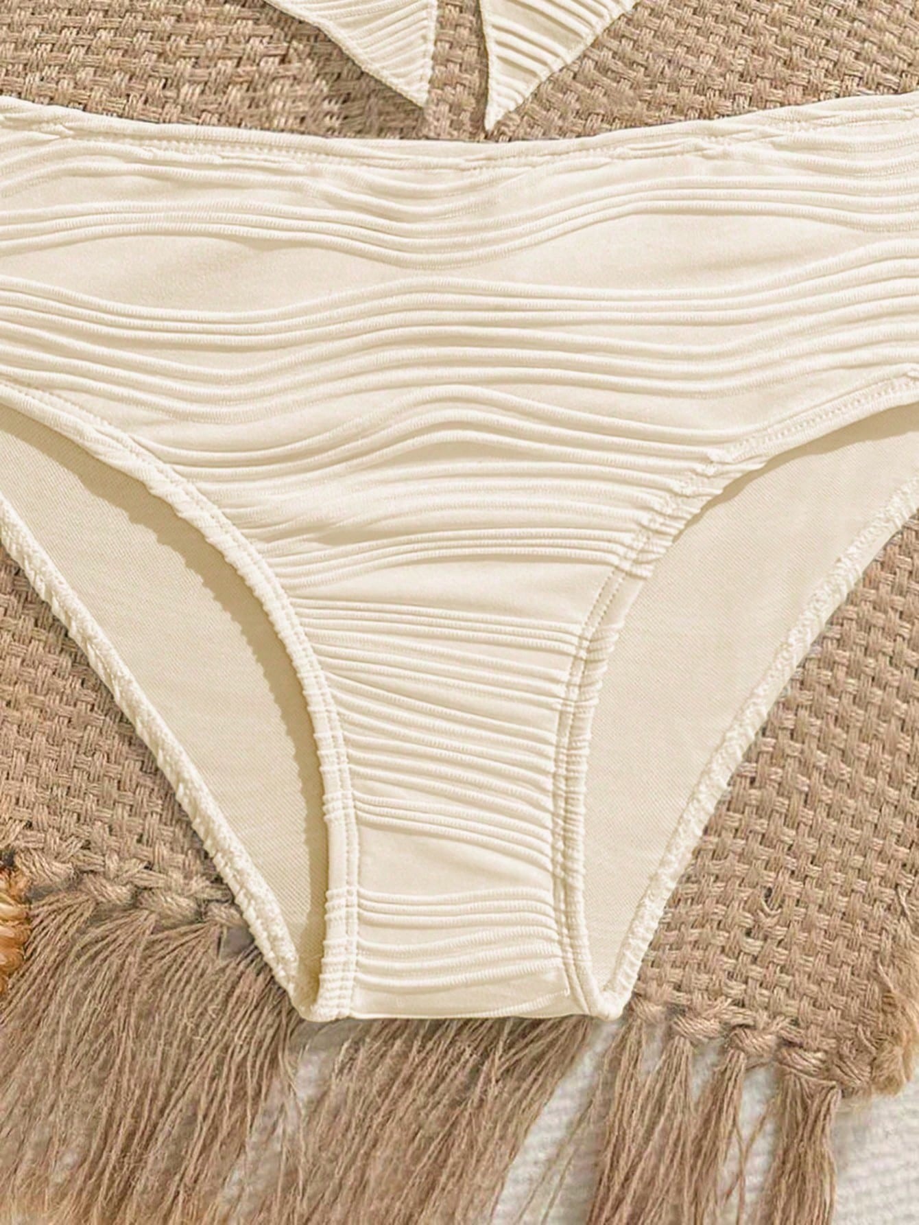 Tween girls 2-piece tankini swimwear set in apricot with a textured jacquard look, asymmetrical spaghetti-strap sleeveless top, and matching mid-waist short bikini bottoms.