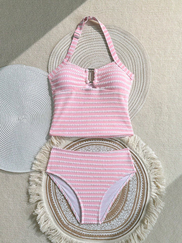 Two-piece tween girls swimwear set in pink with a wavy striped pattern and metallic decor, featuring a halter sleeveless top and mid-waist bottoms in soft, medium-stretch knit fabric, suitable for beach or pool wear.