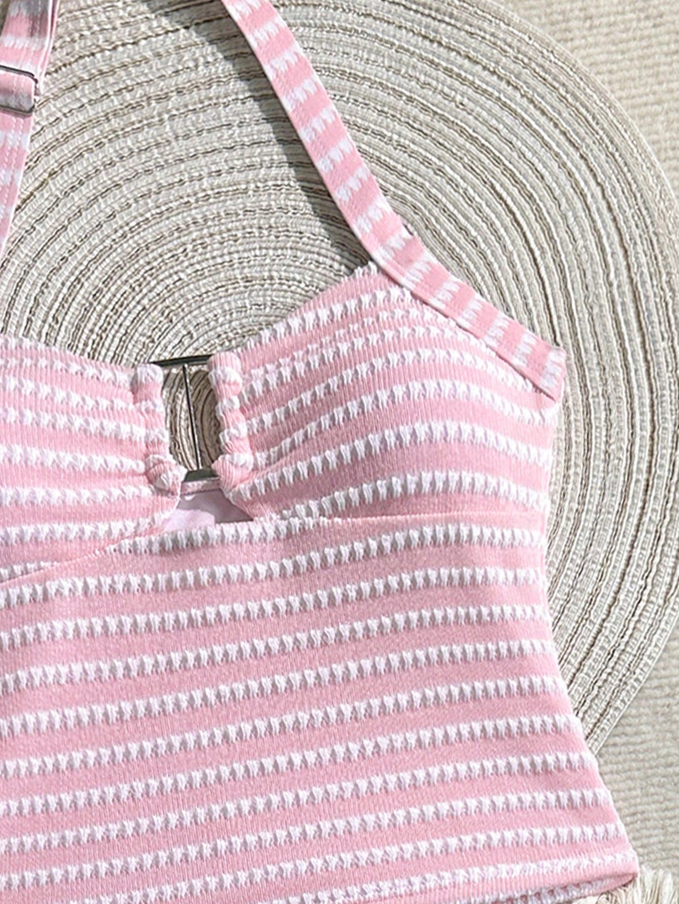 Two-piece tween girls swimwear set in pink with a wavy striped pattern and metallic decor, featuring a halter sleeveless top and mid-waist bottoms in soft, medium-stretch knit fabric, suitable for beach or pool wear.