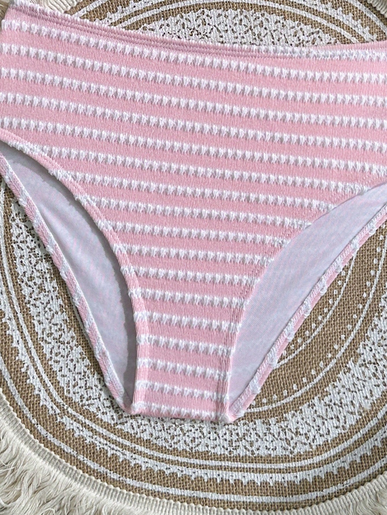 Two-piece tween girls swimwear set in pink with a wavy striped pattern and metallic decor, featuring a halter sleeveless top and mid-waist bottoms in soft, medium-stretch knit fabric, suitable for beach or pool wear.