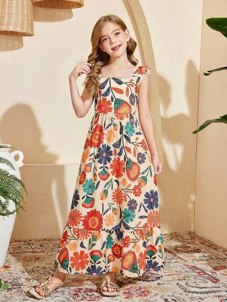 Blue floral print long vacation dress for tween girls featuring an A-line high waist silhouette with ruffle details and spaghetti straps.