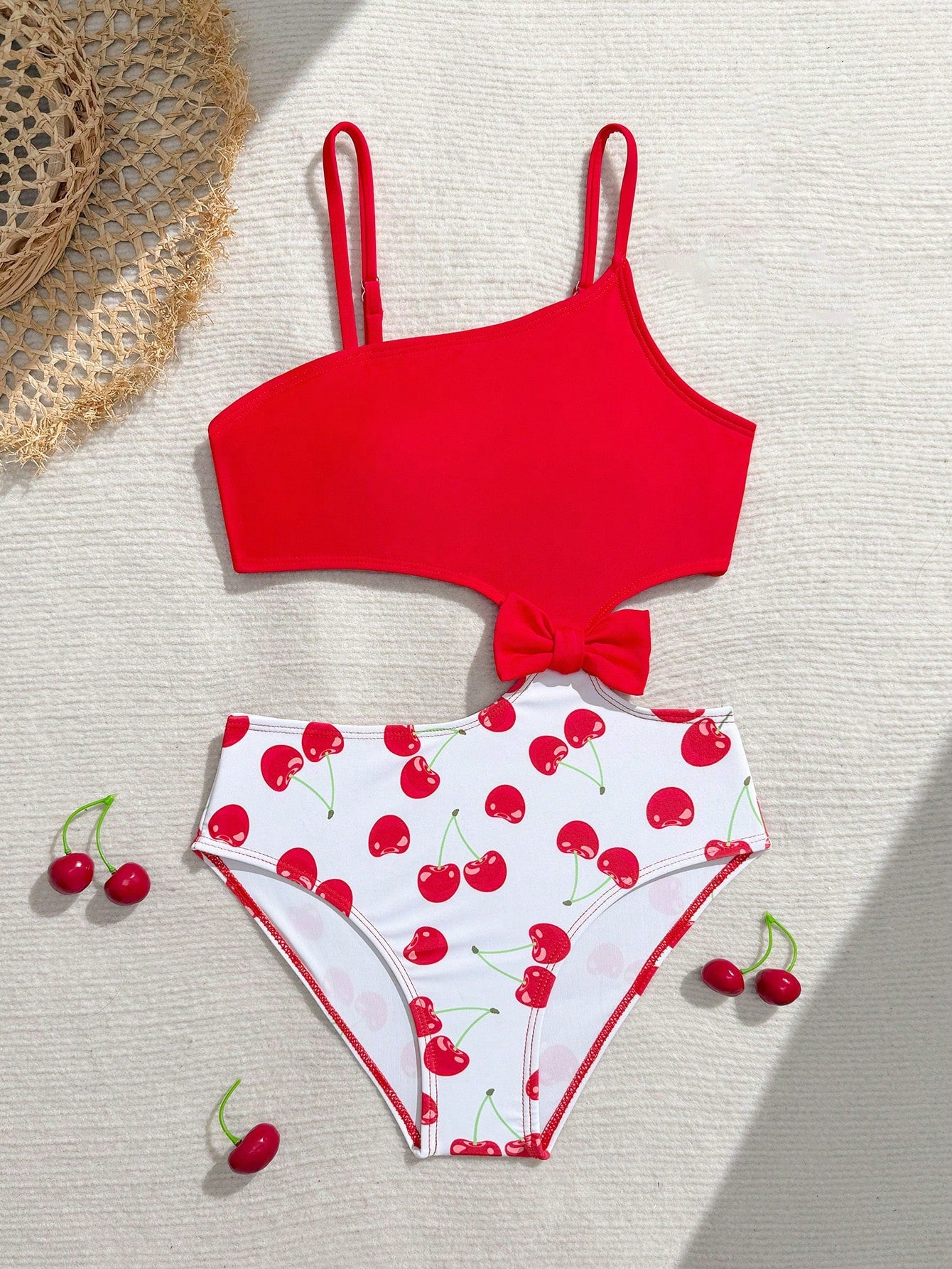 Tween girls one-piece swimsuit featuring an asymmetric neckline, pendant decor, plain design, wireless bra, high-cut bottom, and medium-stretch fabric.