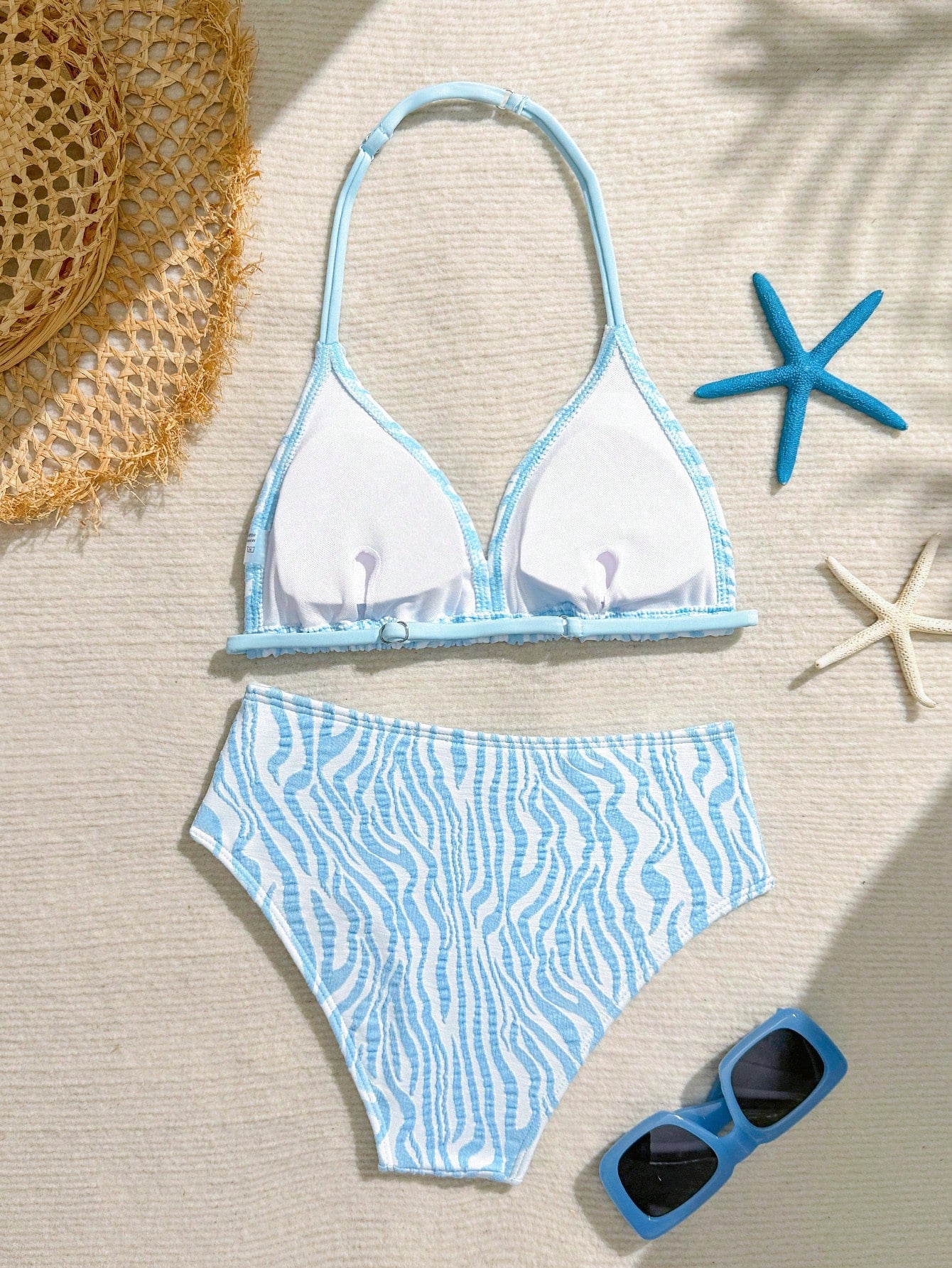 Tween girls blue and white striped two-piece bikini set with halter triangle top and mid-waist short bikini bottoms for beach and vacation swimwear.