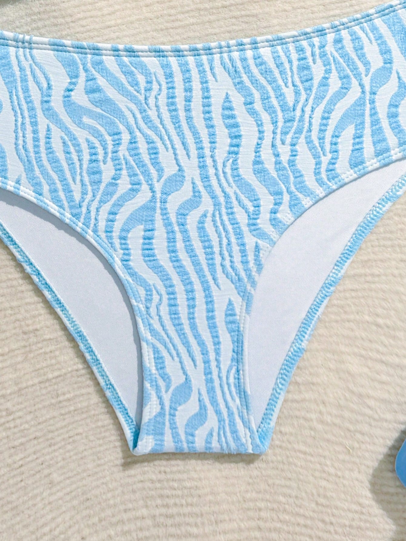 Tween girls blue and white striped two-piece bikini set with halter triangle top and mid-waist short bikini bottoms for beach and vacation swimwear.