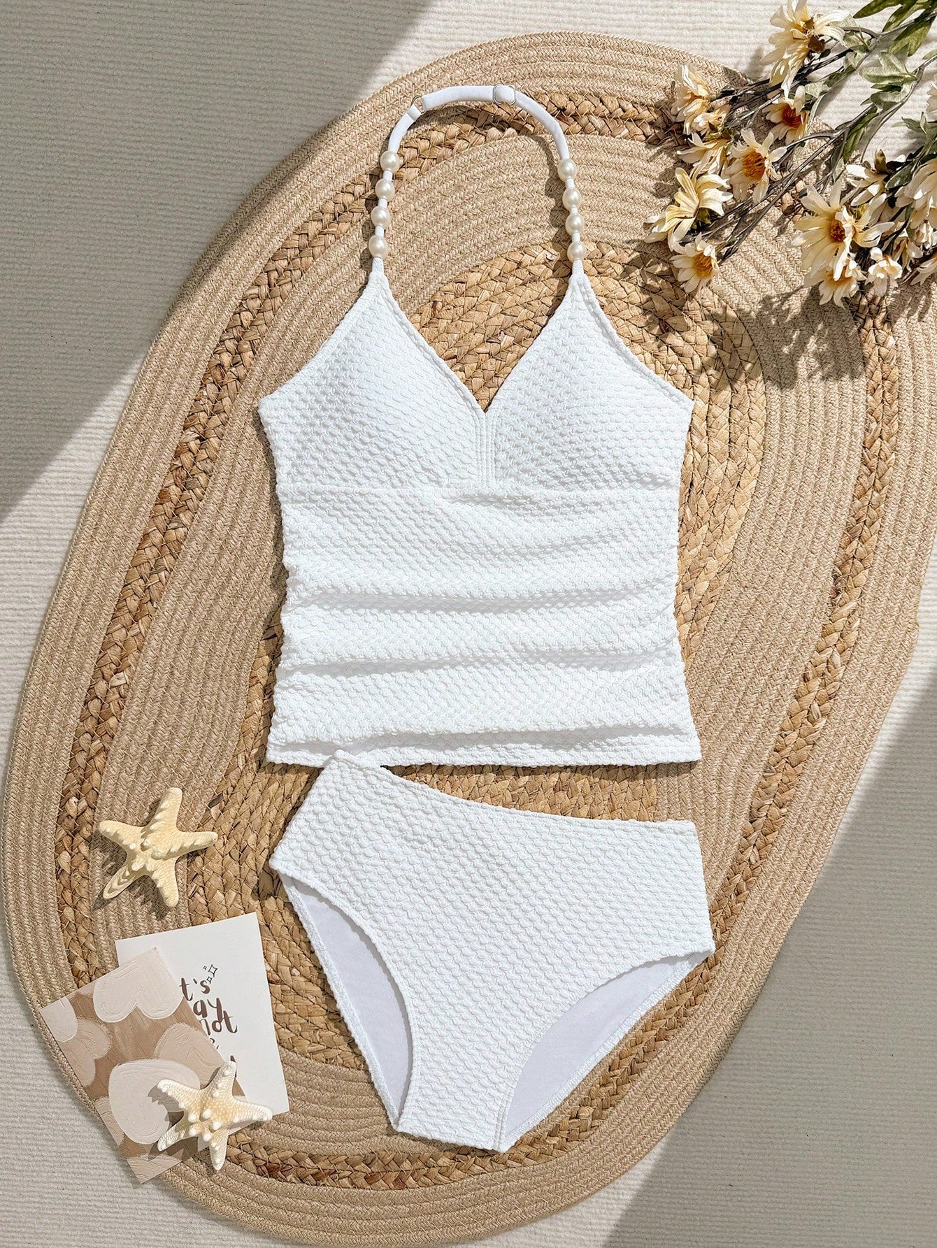 Tween girls 2-piece bikini swimwear set in black with a wave-pattern geometric design, featuring halter neckline, wireless top, and high-waist short bottoms with starfish and shell decor.