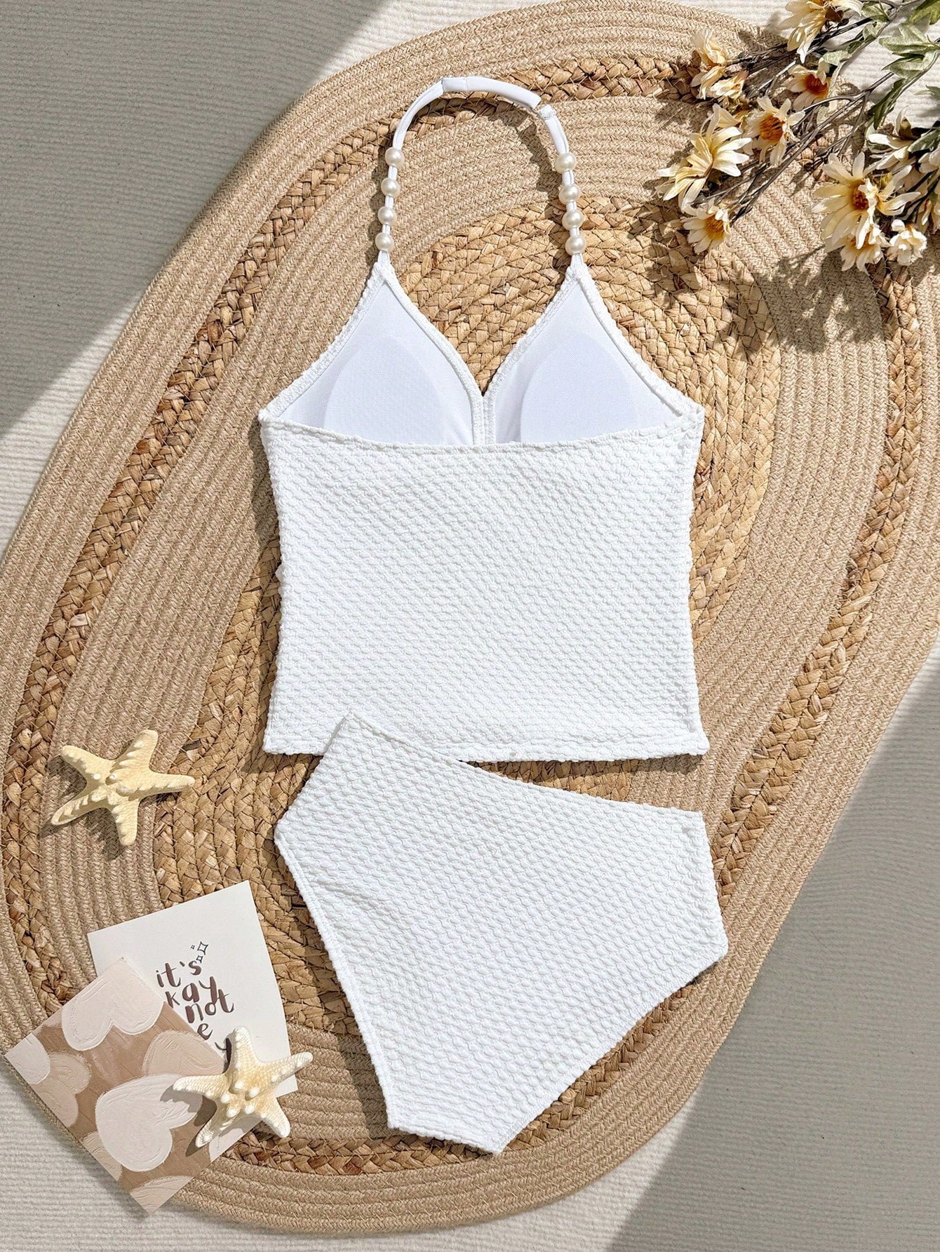 Tween girls 2-piece bikini swimwear set in black with a wave-pattern geometric design, featuring halter neckline, wireless top, and high-waist short bottoms with starfish and shell decor.