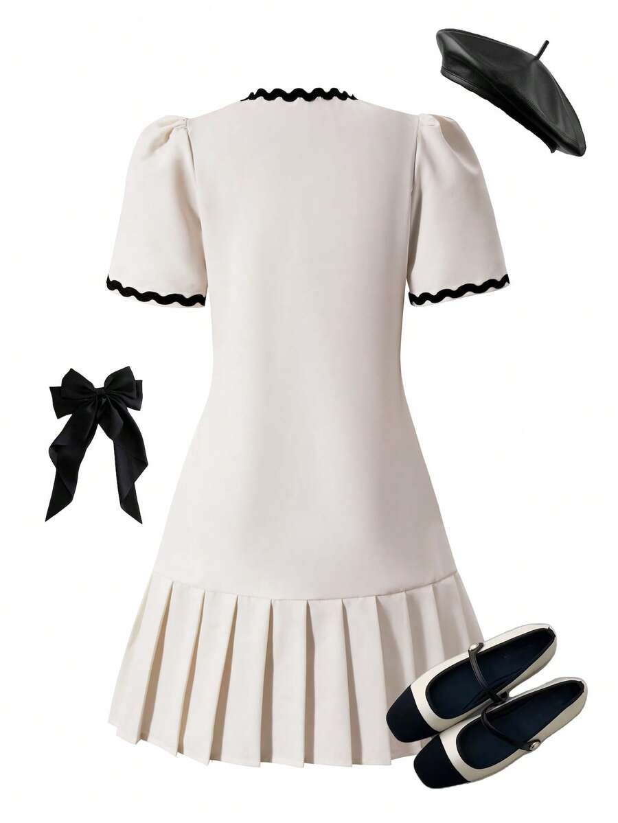 Tween girls apricot short-sleeve pleated smock dress with 3D bow decor and round neckline.