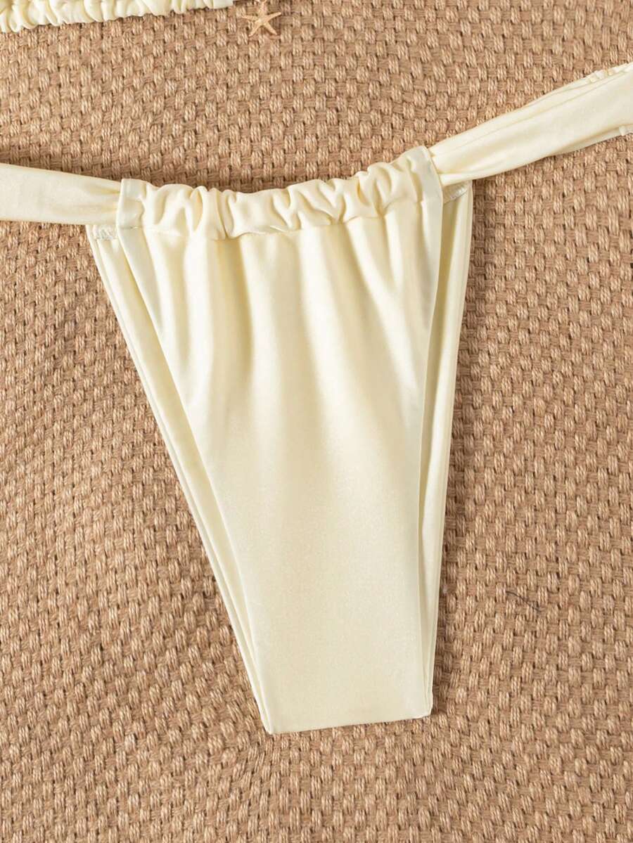 Women's 2-piece triangle cup bikini set in solid color featuring woven pearl shell decoration, halter neckline, and high-waist side-tie ruched bottoms.