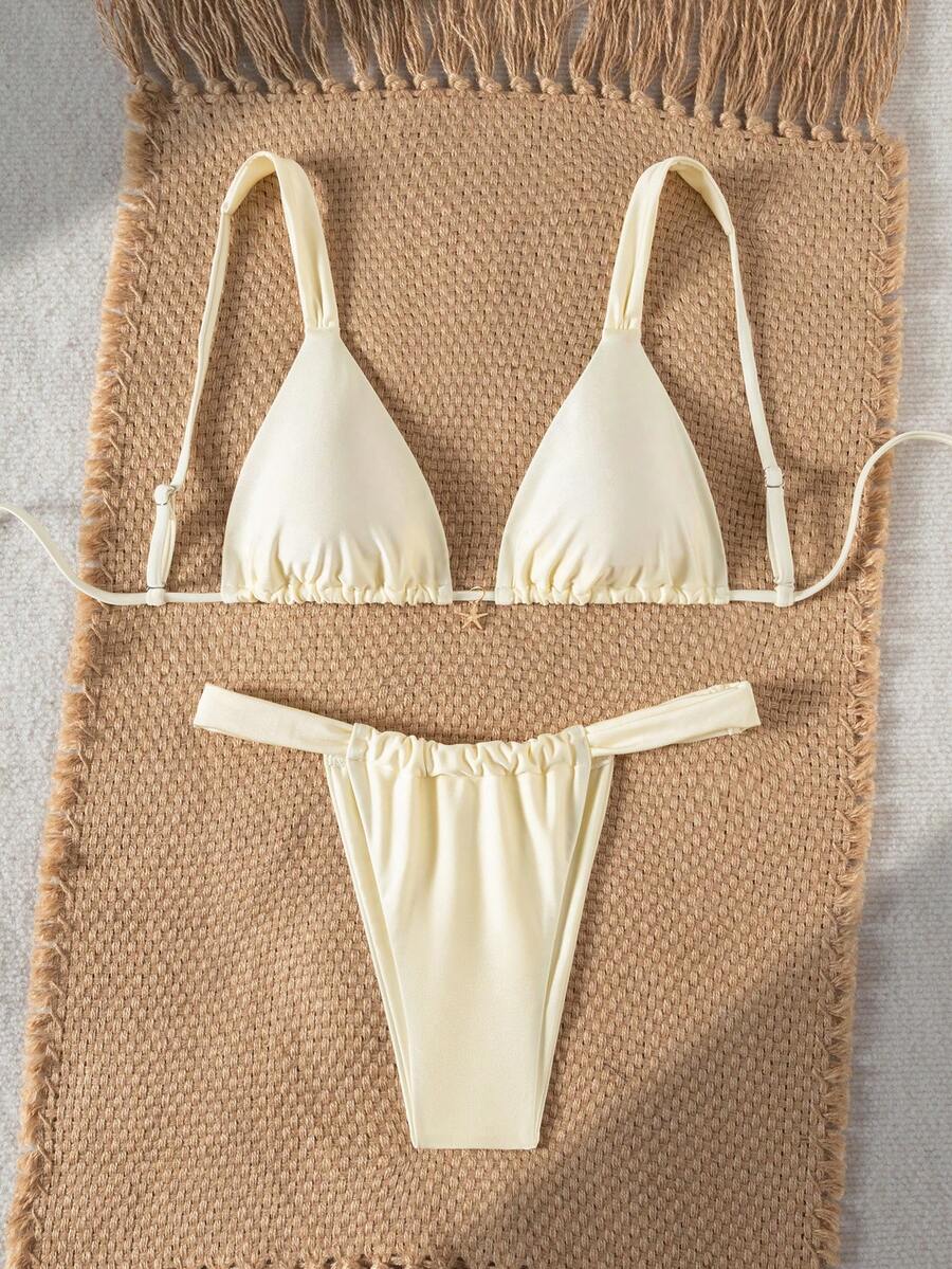 Women's 2-piece triangle cup bikini set in solid color featuring woven pearl shell decoration, halter neckline, and high-waist side-tie ruched bottoms.