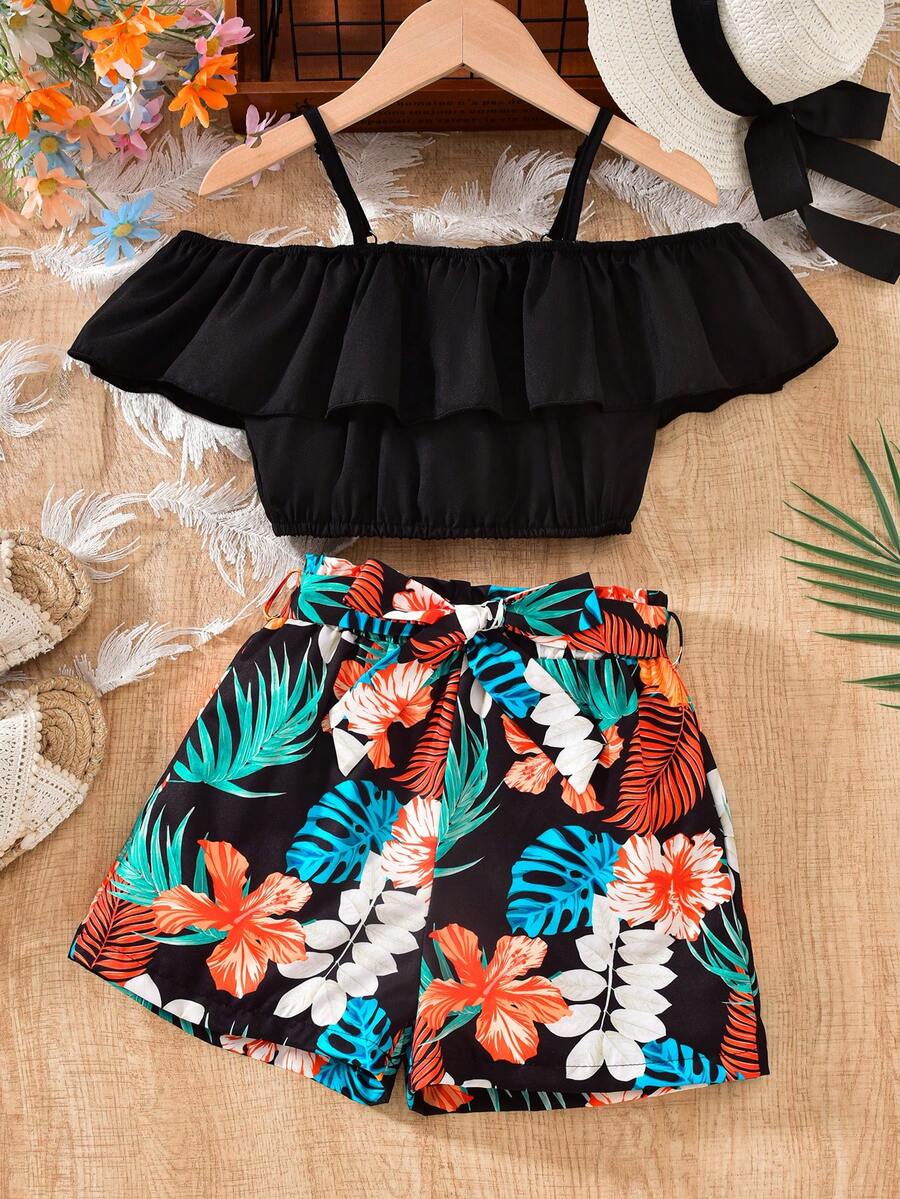 Tween girls 2-piece summer set featuring a black off-shoulder crop top with spaghetti straps and tropical leaf print ruffled paperbag waist shorts with a matching belt.