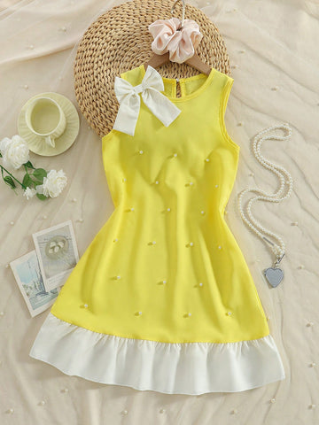 Yellow sleeveless colorblock dress for girls featuring a round neck, ruffle hem, and front bow detail.