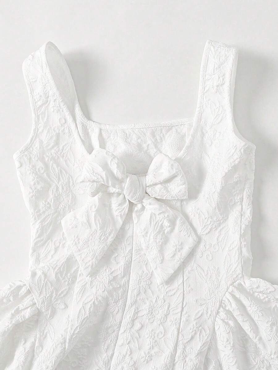 Black and white polka dot cami dress for tween girls featuring a square neckline, high waist, and flared short A-line hem.