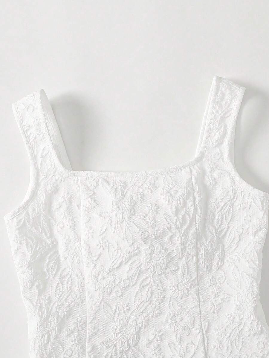 Black and white polka dot cami dress for tween girls featuring a square neckline, high waist, and flared short A-line hem.
