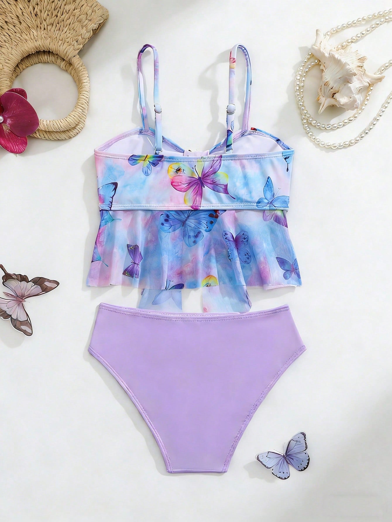 Tween girls two-piece tankini swimwear set with spaghetti straps, asymmetrical design, and 3D rose detail. Features a plant-pattern top and mid-waist bottoms in stretchy fabric for beach or pool wear.