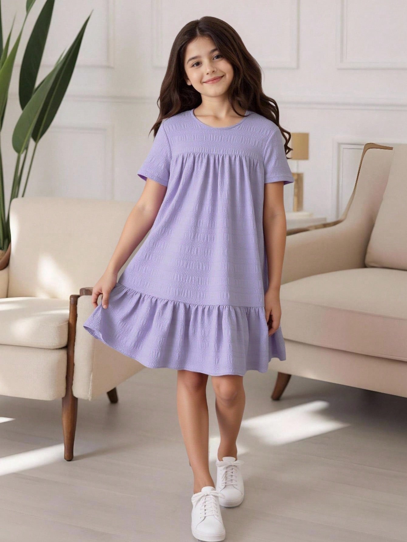 Tween girl wearing an Army Green textured short sleeve smock midi dress with round neck and ruffle flounce hem.