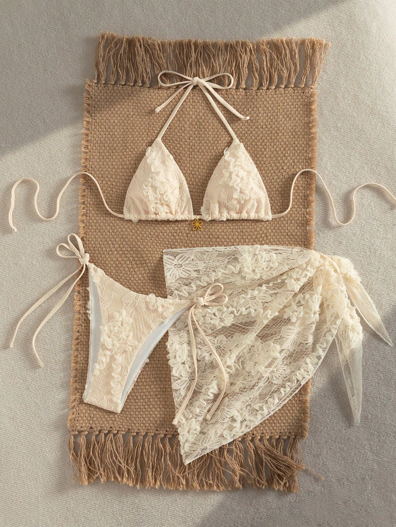 Women's 3-piece blue tropical shell print bikini set featuring a halter bralette top, low-waist tie-side bottom, and a matching sheer mesh cover-up skirt.