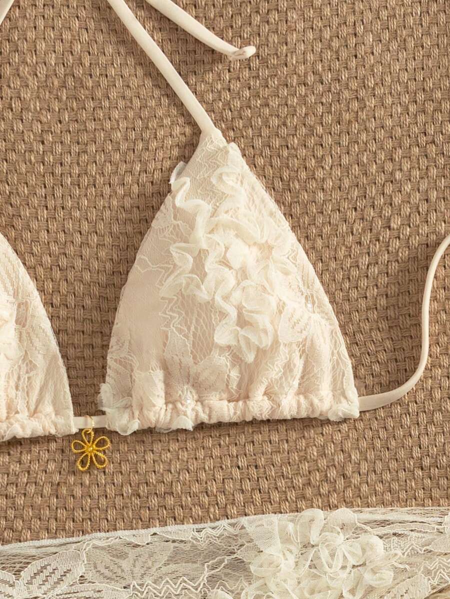 Women's 3-piece blue tropical shell print bikini set featuring a halter bralette top, low-waist tie-side bottom, and a matching sheer mesh cover-up skirt.