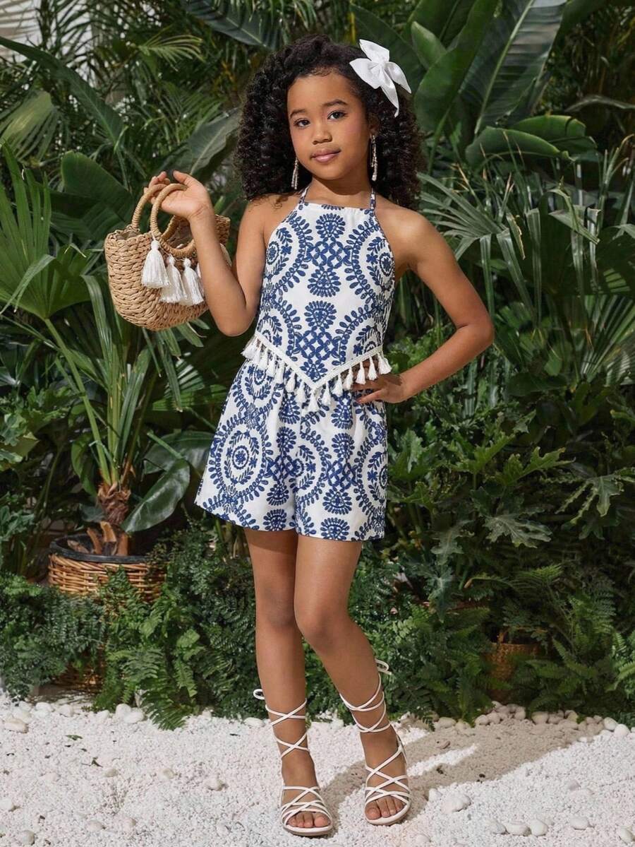 Tween girl wearing a blue tropical paisley print backless halter cami top and matching shorts set.