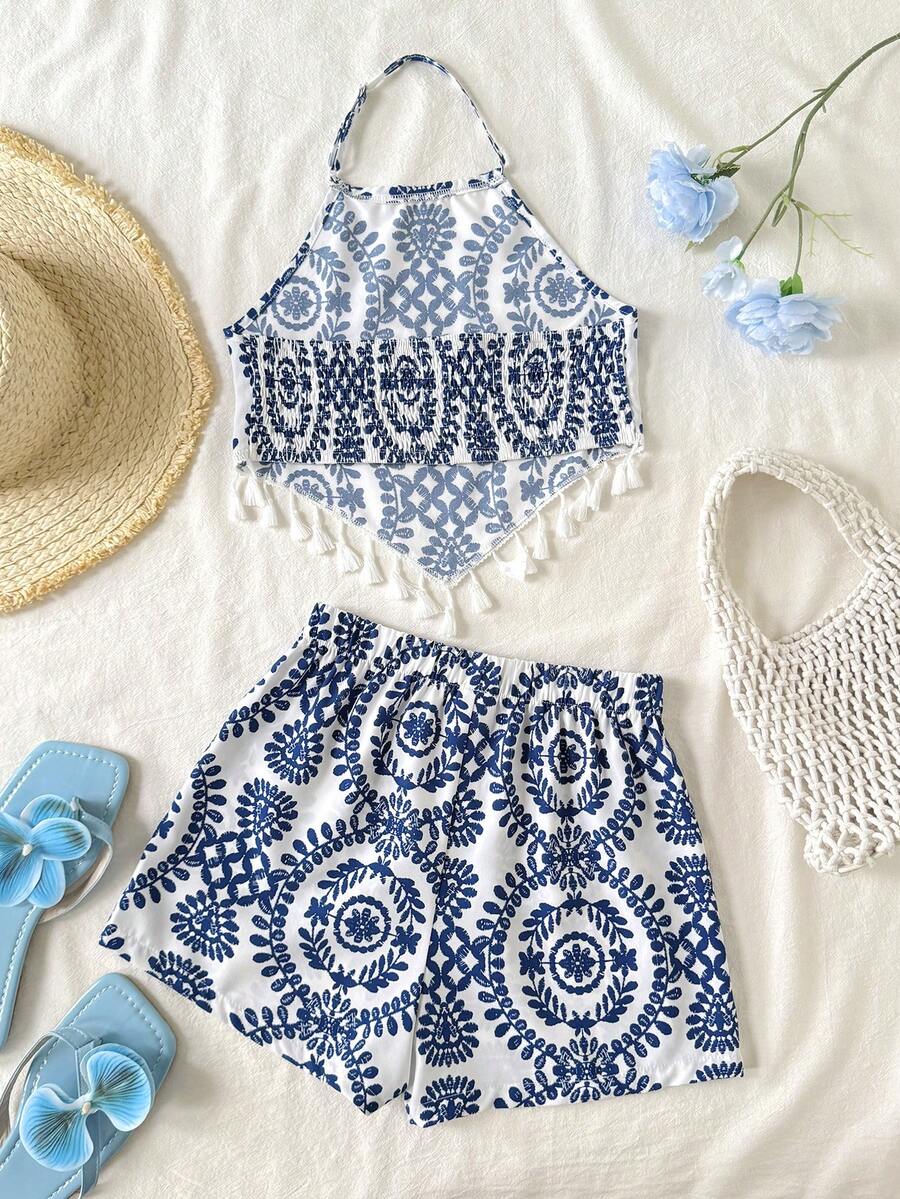Tween girl wearing a blue tropical paisley print backless halter cami top and matching shorts set.