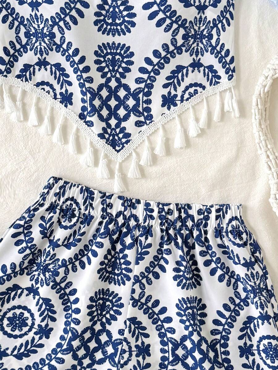 Tween girl wearing a blue tropical paisley print backless halter cami top and matching shorts set.