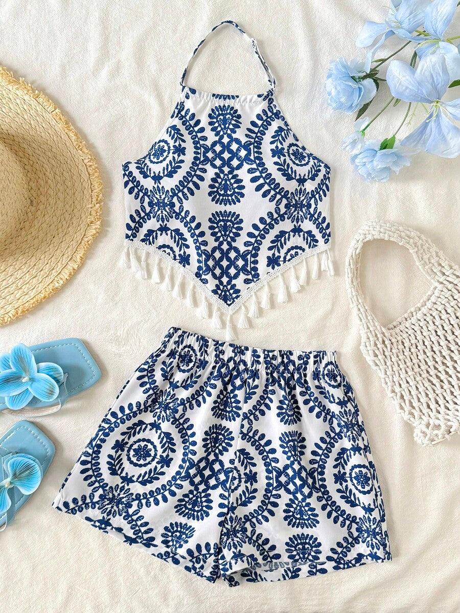 Tween girl wearing a blue tropical paisley print backless halter cami top and matching shorts set.