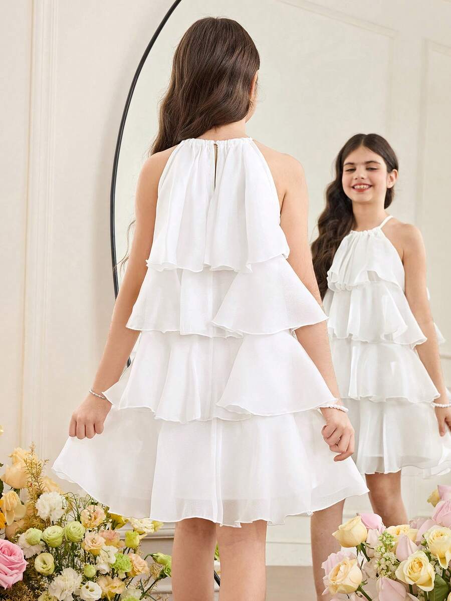 Apricot all-over floral print midi dress for tween girls featuring a sleeveless V-neckline, high waist, button details, and tiered A-line skirt.