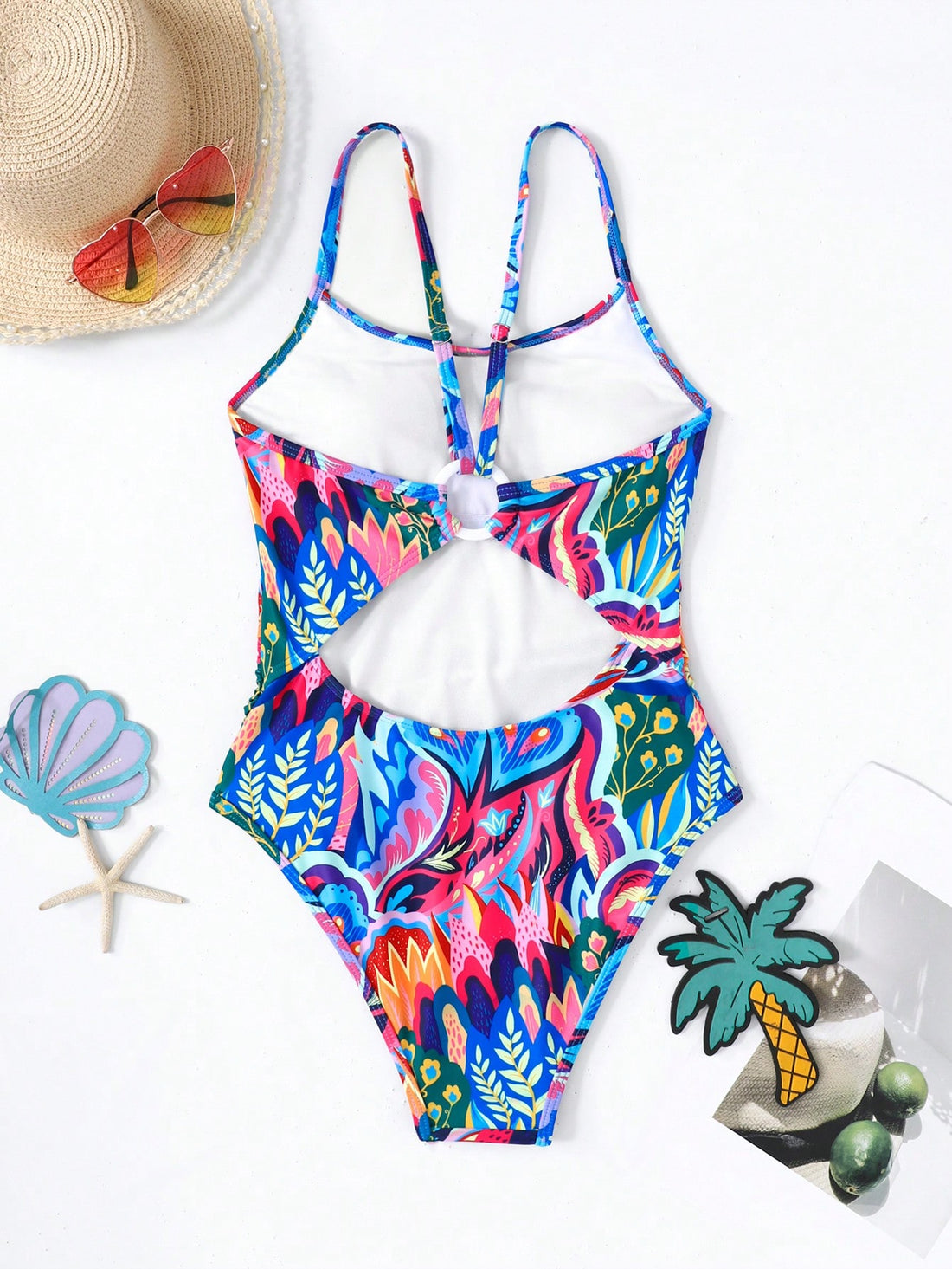 Pink allover print one-piece swimsuit for tween girls with spaghetti straps, lined body, wireless bra, and mid-waist bottom for beach or summer vacation.