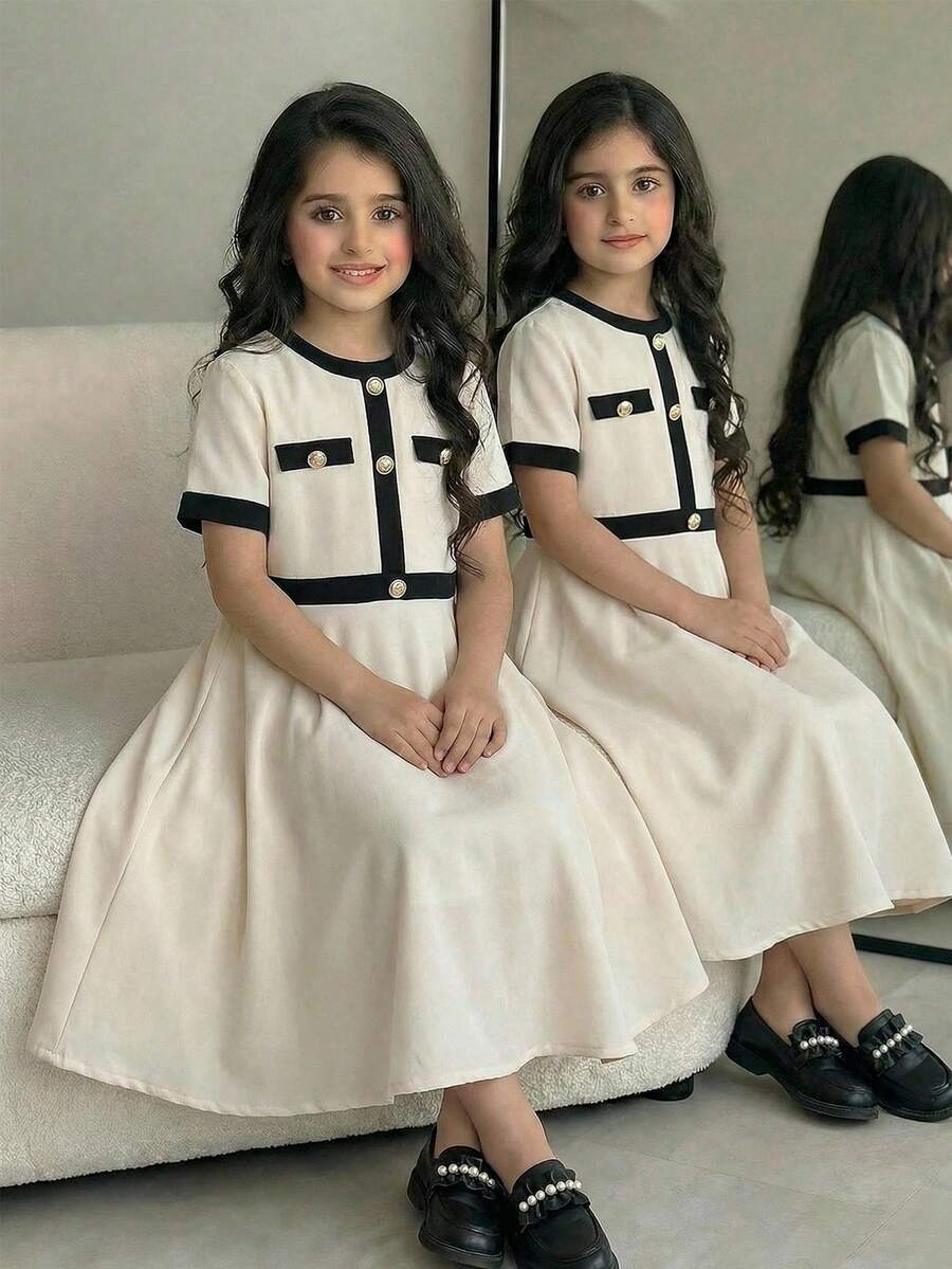 Nova Glow tween girls black and white houndstooth print short sleeve A-line dress with decorative buttons and crew neckline.