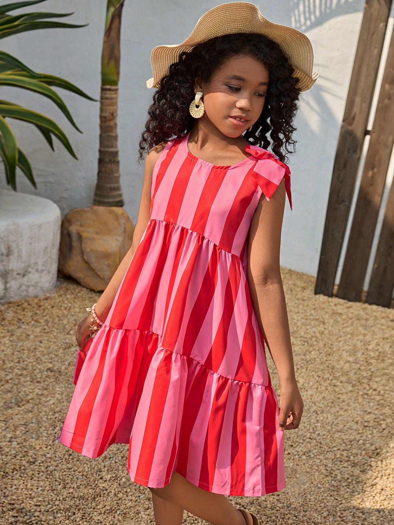 Tween girls blue striped sleeveless smock dress featuring a round neckline, high waist, and flounce ruffle hem.
