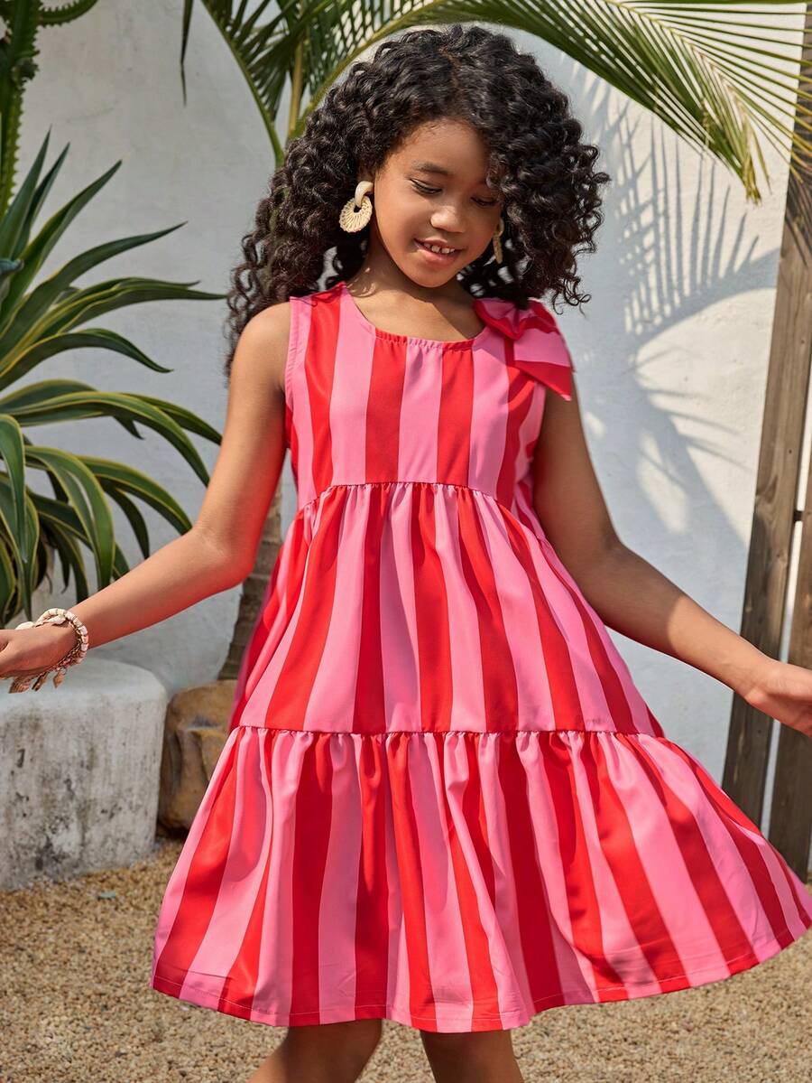 Tween girls blue striped sleeveless smock dress featuring a round neckline, high waist, and flounce ruffle hem.