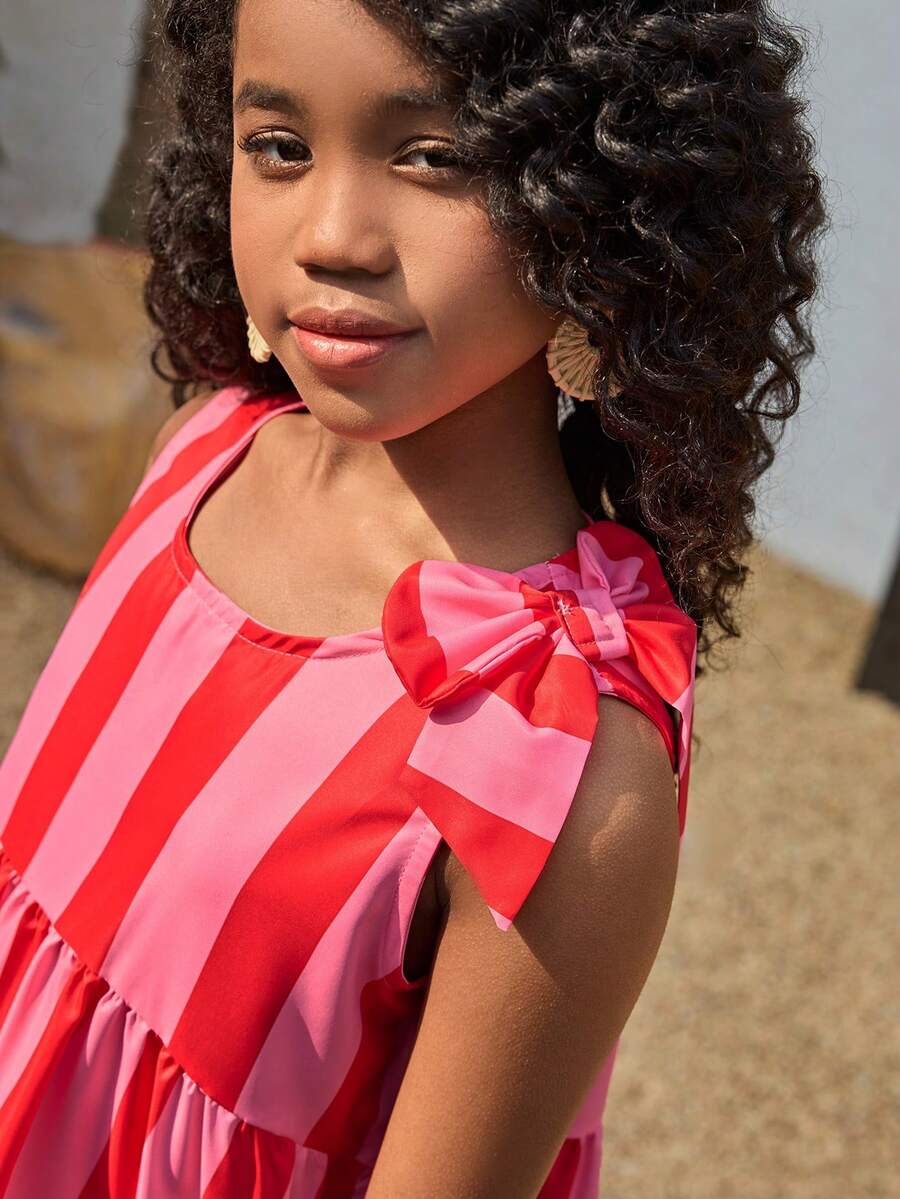 Tween girls blue striped sleeveless smock dress featuring a round neckline, high waist, and flounce ruffle hem.
