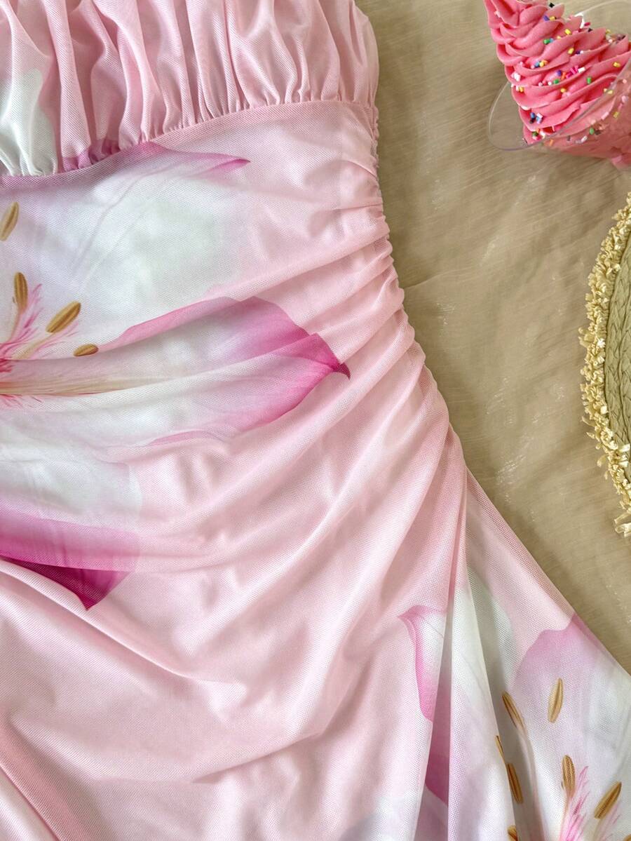 Tween girl yellow mini sundress with large pink floral hibiscus print, spaghetti straps, high waist, flared hem, and sleeveless cami style for summer beach wear