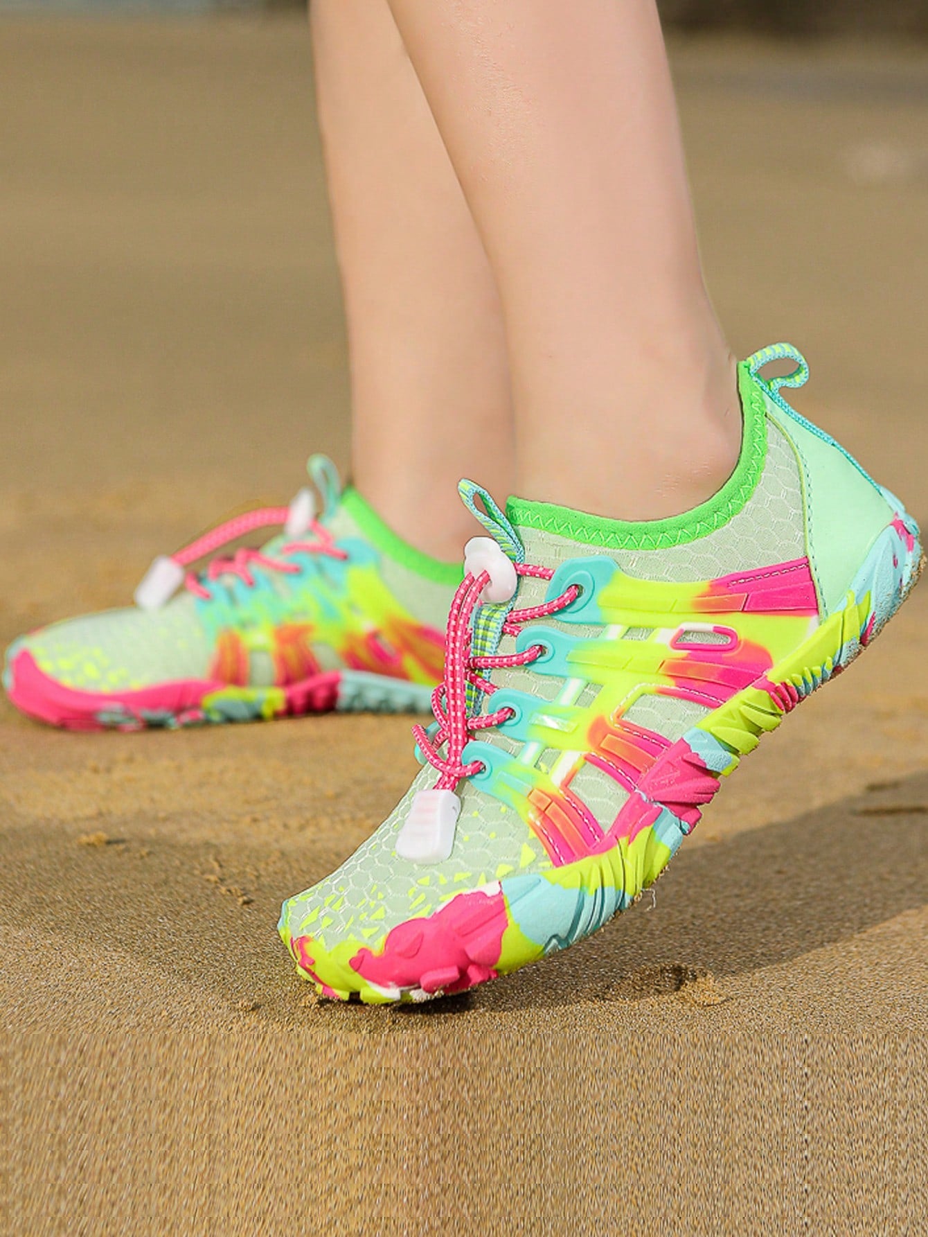 Girls purple quick-drying water shoes featuring a geometric pattern, slip-on fit with lace-up detail, and rubber outsole.