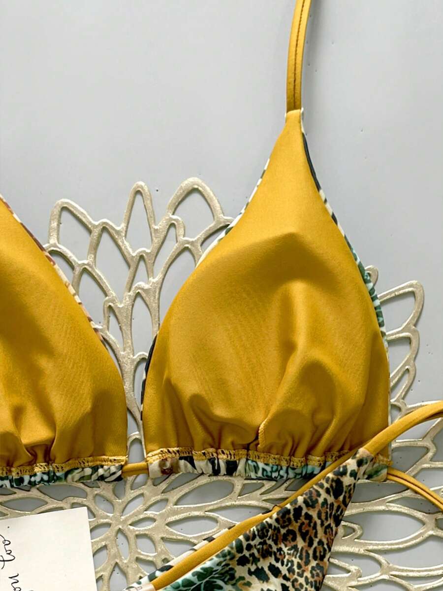 Women's vintage leopard print 2-piece bikini set featuring a high waist tie-side bottom and a halter neck triangle top.