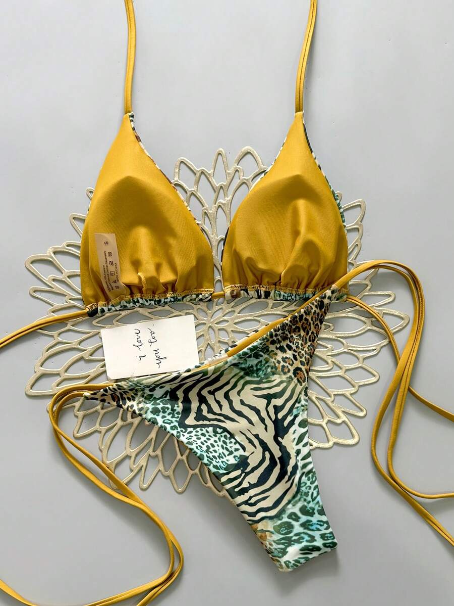 Women's vintage leopard print 2-piece bikini set featuring a high waist tie-side bottom and a halter neck triangle top.
