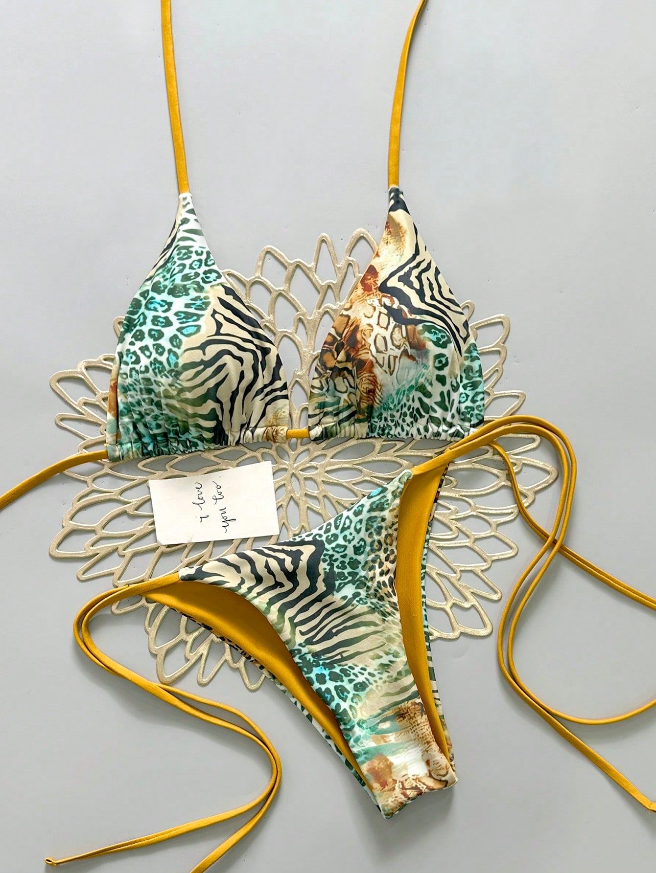 Women's vintage leopard print 2-piece bikini set featuring a high waist tie-side bottom and a halter neck triangle top.