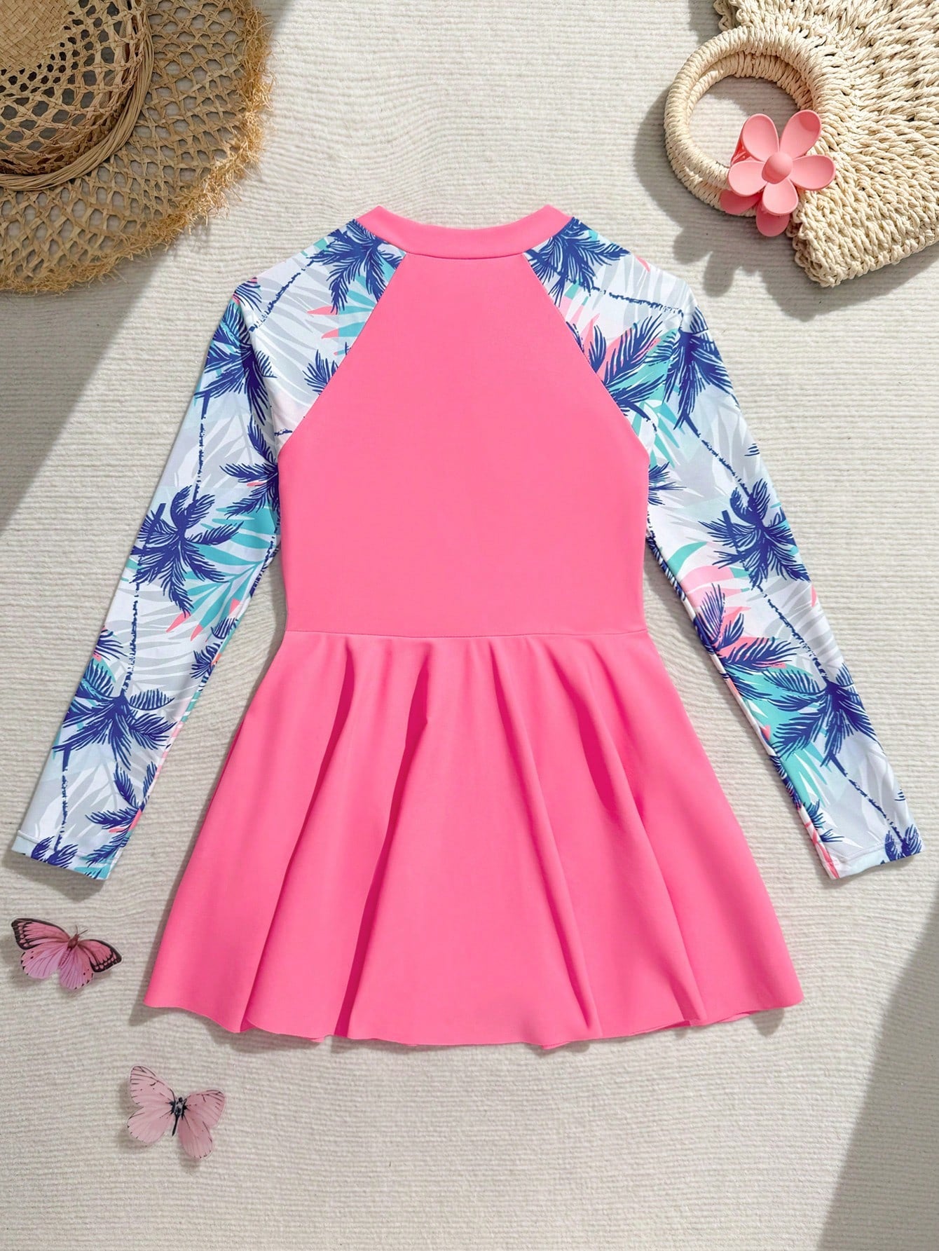 Tween girls one-piece swimsuit in black floral pattern with long sleeves, high neck, front zipper, and a skirt-style bottom.
