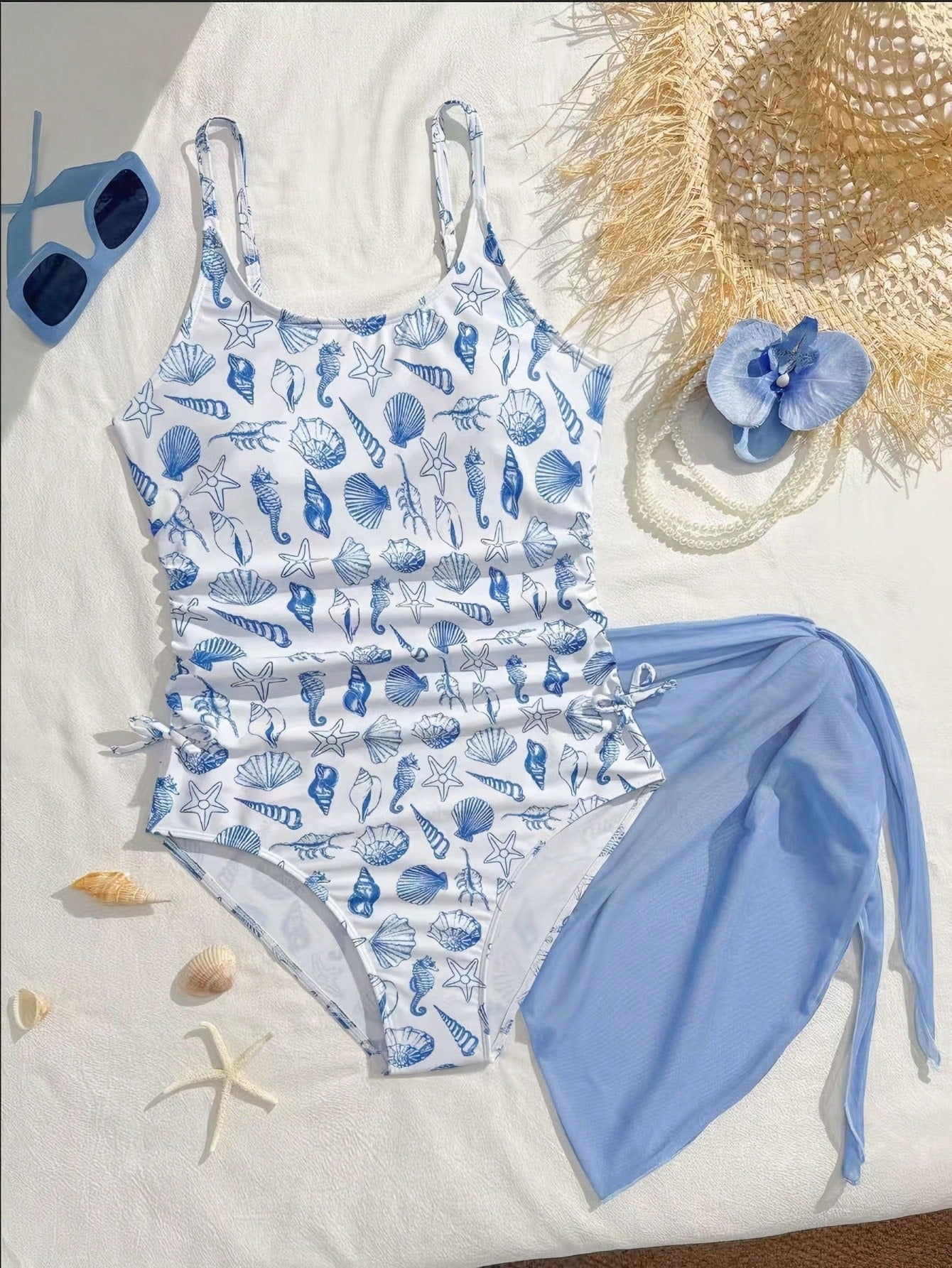Tween girls 2-piece swimsuit in black with pink floral print, featuring spaghetti straps, bow decor, mesh detail, and a skirted mid-waist bottom. Sleeveless vacation-style swim set with medium-stretch fabric.