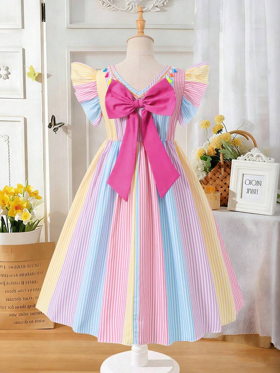Tween girls blue short smock dress featuring flounce short sleeves, high waist flared hem, round neck, and front bow detail.