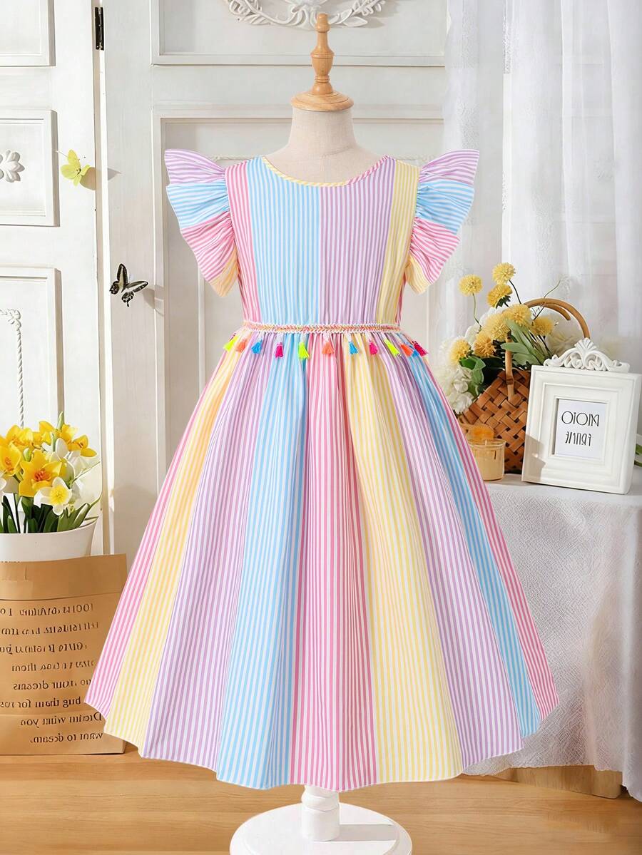 Tween girls blue short smock dress featuring flounce short sleeves, high waist flared hem, round neck, and front bow detail.
