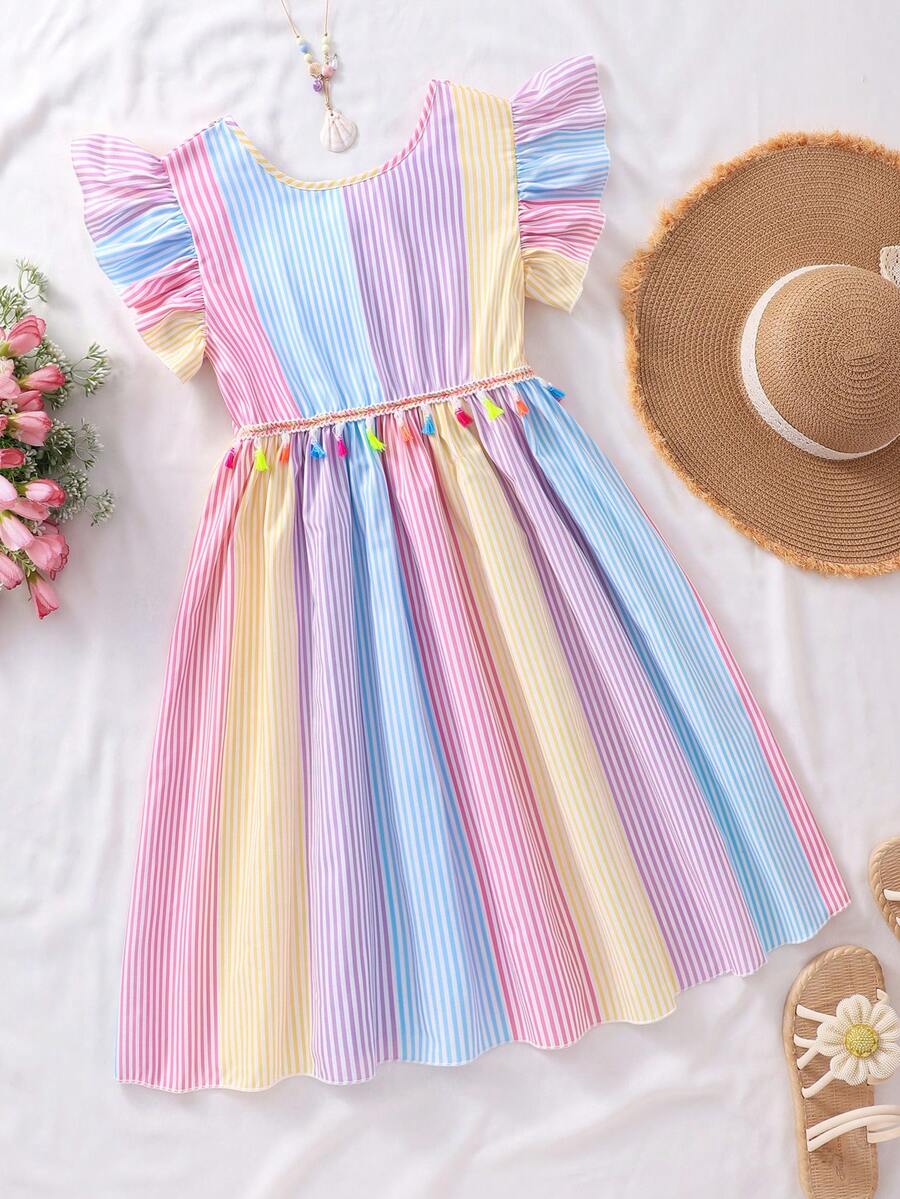 Tween girls blue short smock dress featuring flounce short sleeves, high waist flared hem, round neck, and front bow detail.