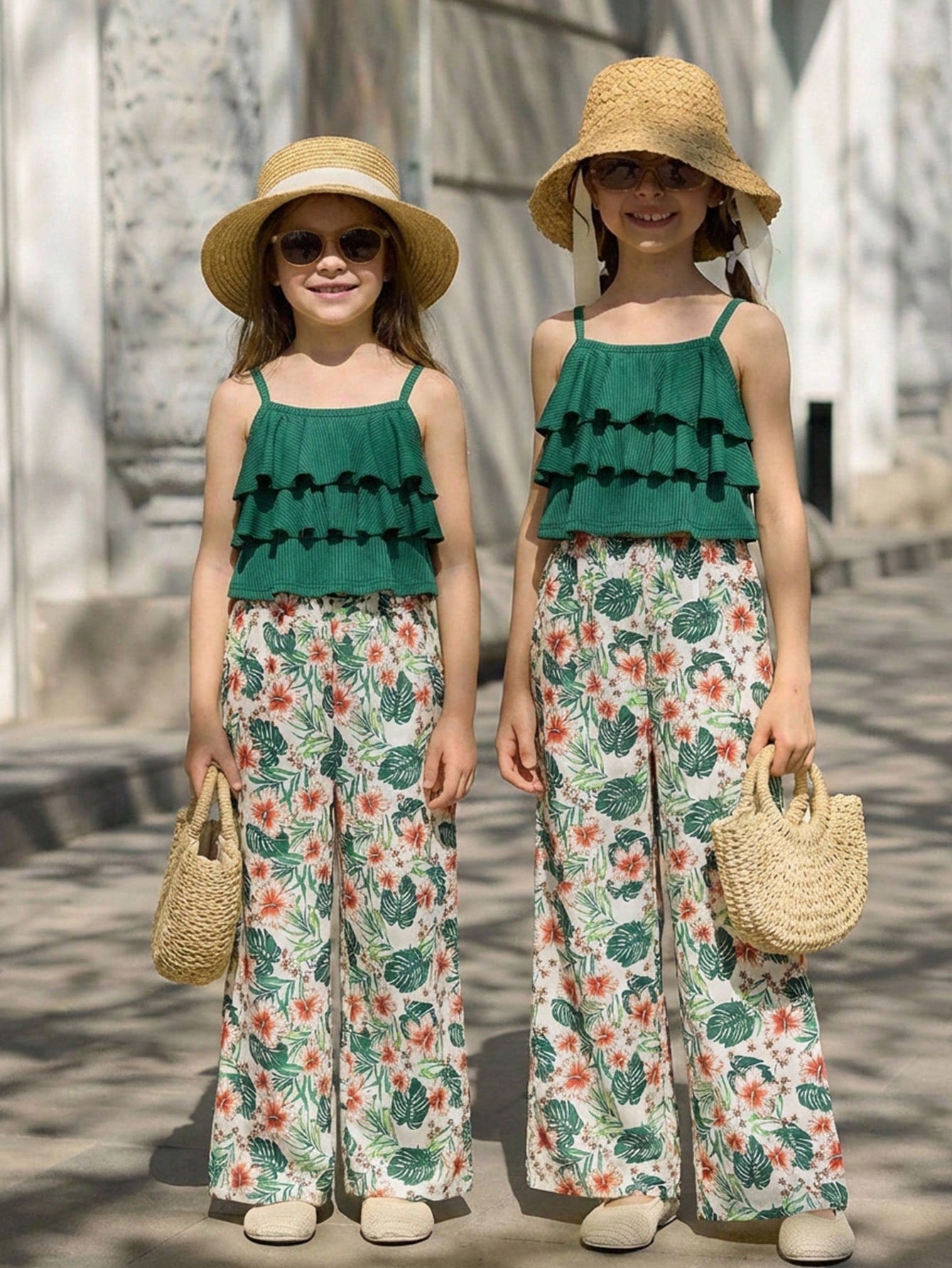 Tween girls blue 2-piece vacation outfit set featuring a tiered ruffle spaghetti strap camisole and loose high-waist pants.