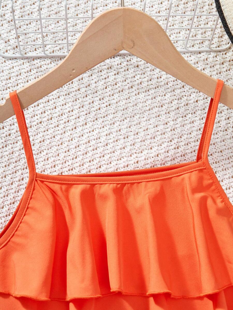 Tween girls blue 2-piece vacation outfit set featuring a tiered ruffle spaghetti strap camisole and loose high-waist pants.