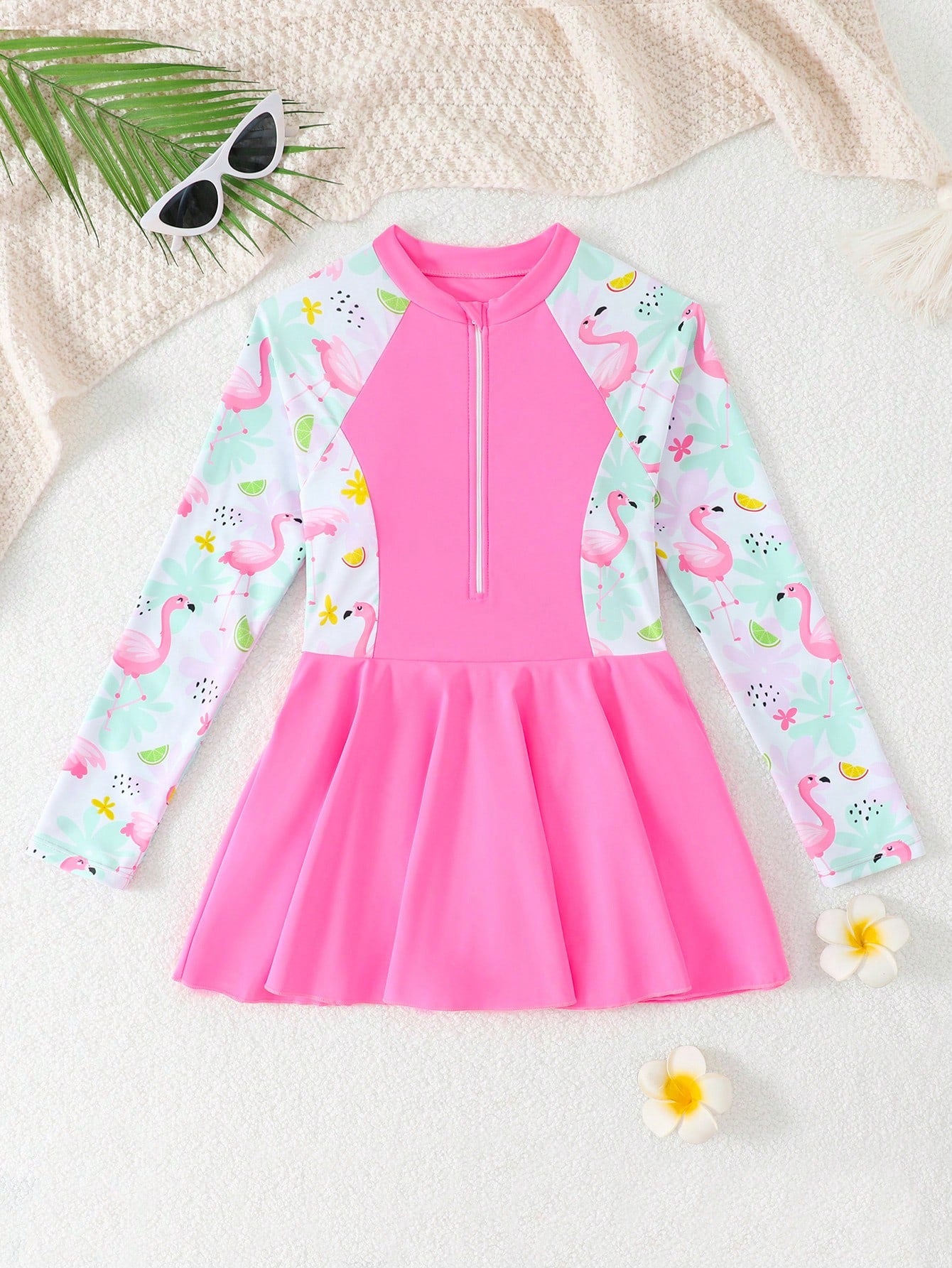 Tween girls one-piece swimsuit in black floral pattern with long sleeves, high neck, front zipper, and a skirt-style bottom.