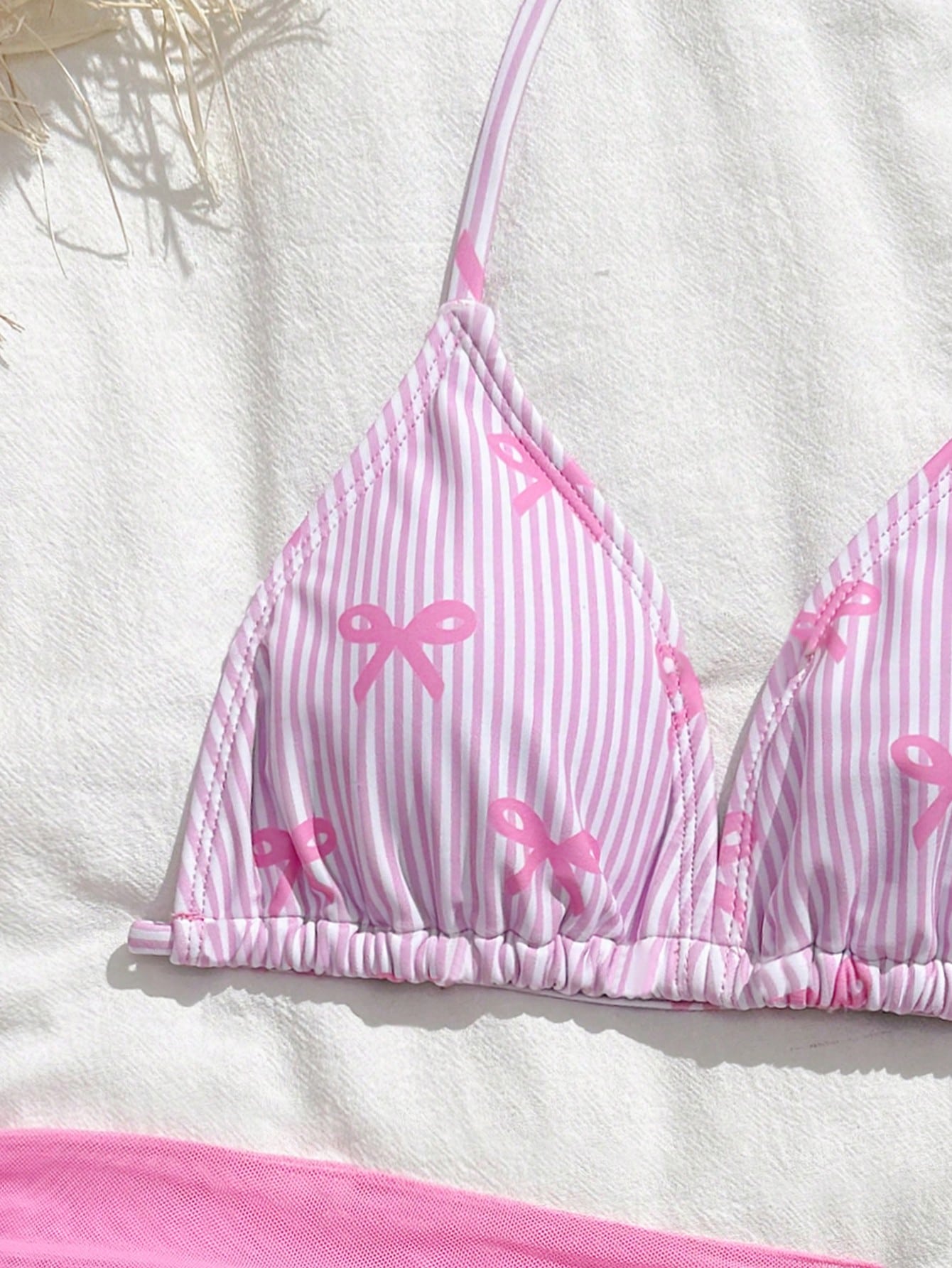 Tween girls 3-piece swimwear set in pink featuring a striped triangle halter bikini top with bow detail and adjustable neck and back ties, an adjustable mid-waist bikini bottom, and a sheer pink mesh skirt cover-up for beach or pool wear.