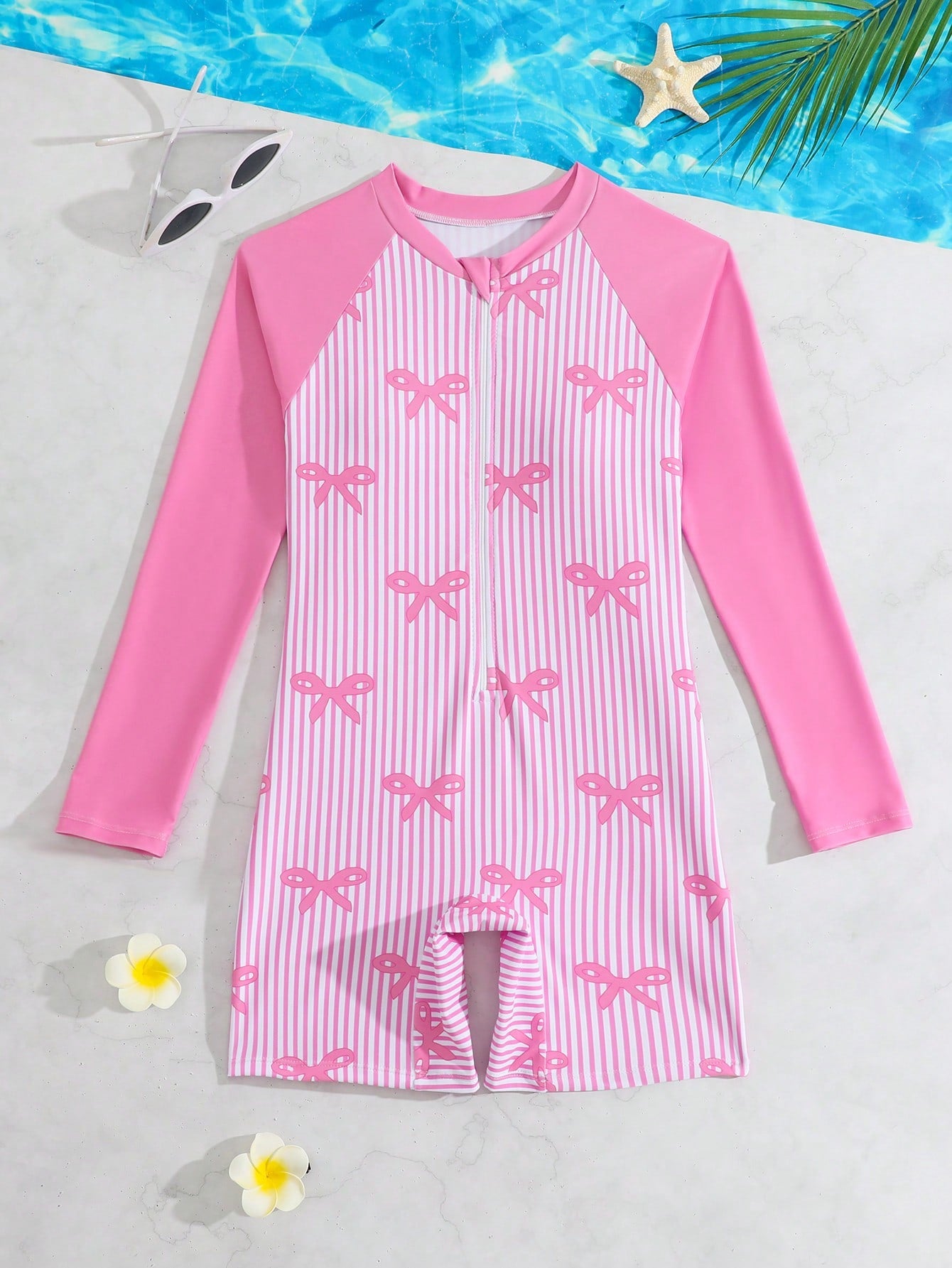 Tween girls one-piece swimsuit featuring a high neck, long sleeves, and shorts bottom, with a back zipper and strawberry plaid digital print on stretch knit fabric. Designed for swimming, vacation, and summer wear.