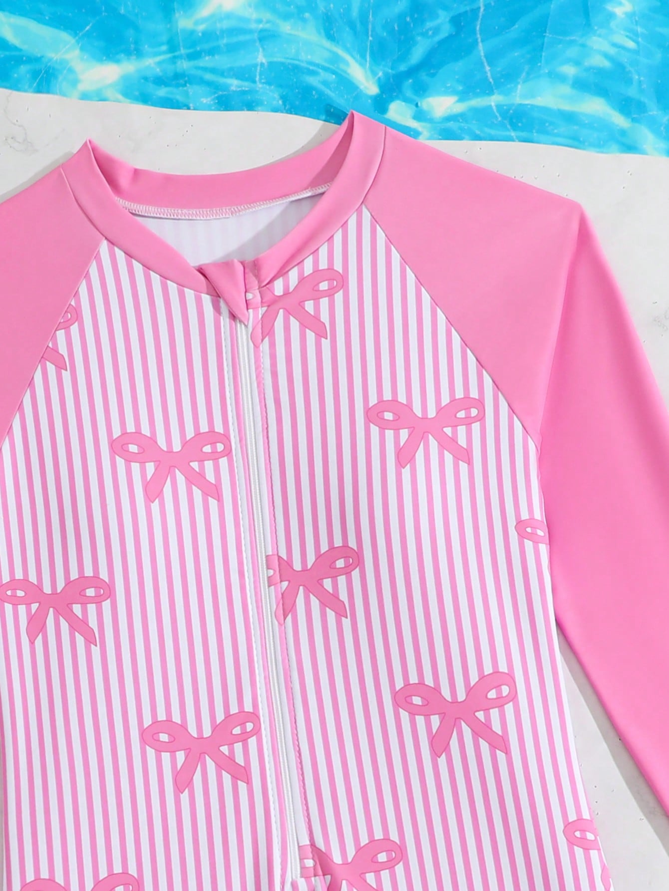 Tween girls one-piece swimsuit featuring a high neck, long sleeves, and shorts bottom, with a back zipper and strawberry plaid digital print on stretch knit fabric. Designed for swimming, vacation, and summer wear.