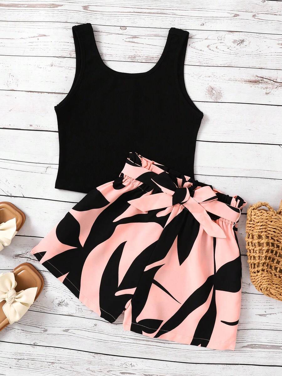 Tween girl wearing a casual 2-piece set featuring a black rib-knit scoop neck tank top and leopard print paperbag waist shorts with a matching belt.