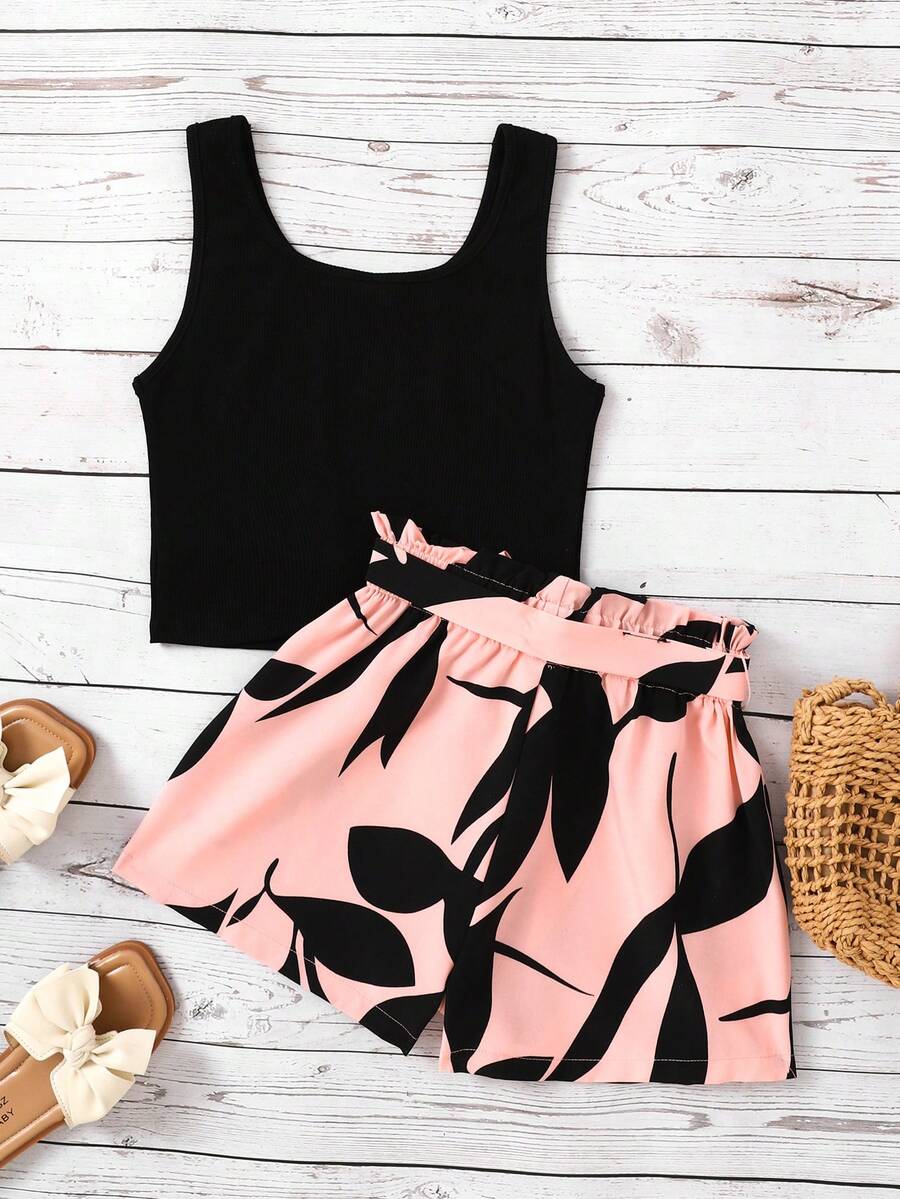 Tween girl wearing a casual 2-piece set featuring a black rib-knit scoop neck tank top and leopard print paperbag waist shorts with a matching belt.