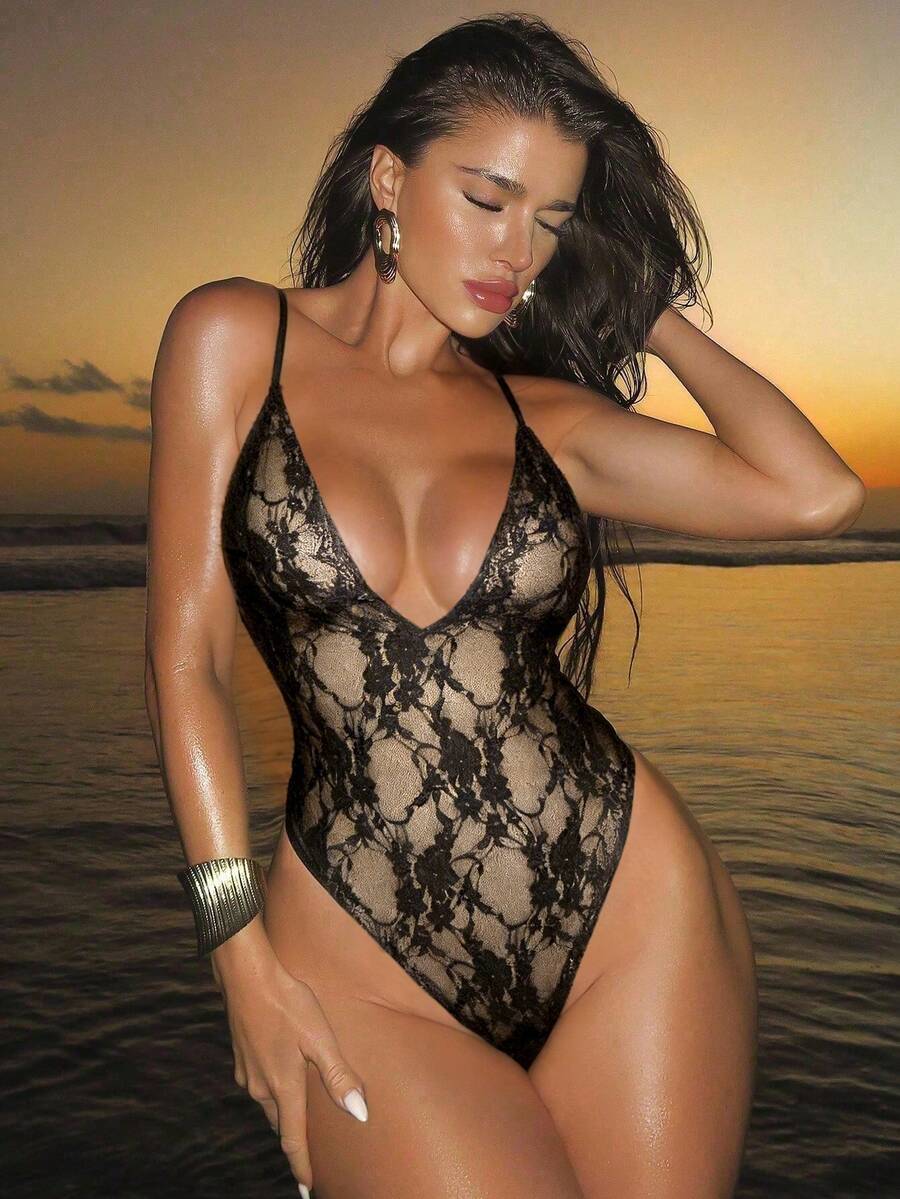 Women's black lace one-piece swimsuit featuring a deep V-neckline, spaghetti straps, backless tie-up detail, and thong bottom.